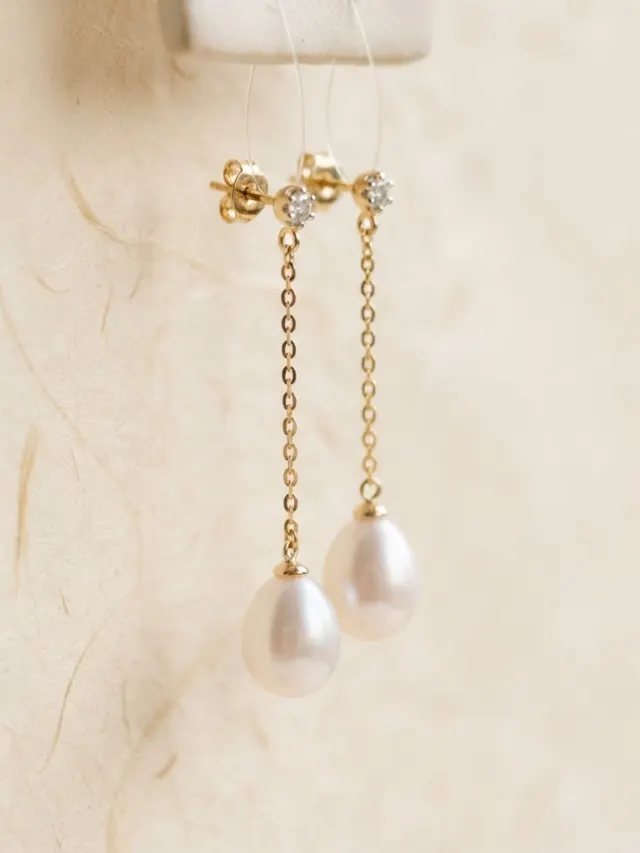 Pearl-style drop earrings hanging delicately